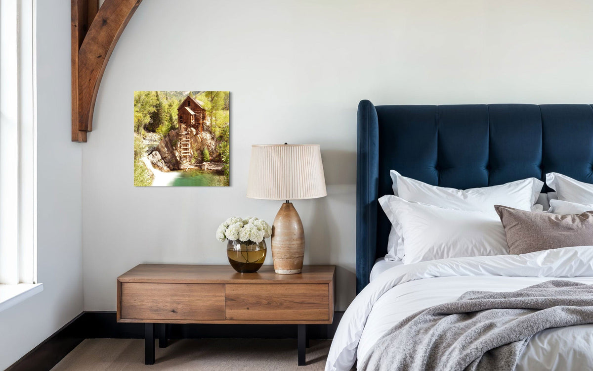 A piece of Colorado art showing a Crystal Mill photo hangs over a bedside table.