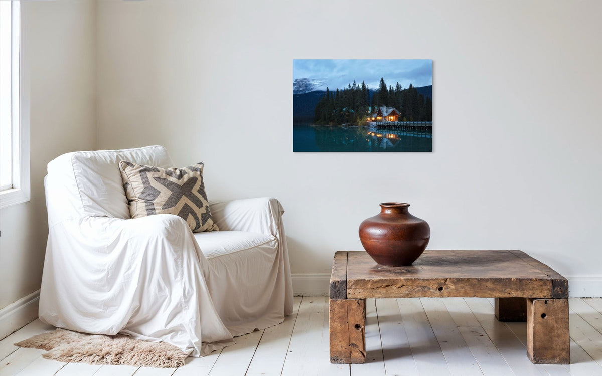A piece of Banff art showing an Emerald Lake Lodge photo hangs in a living room.