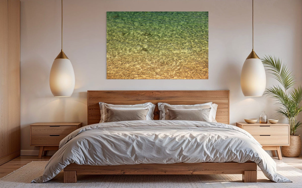 A piece of Kauai art showing the colors of the water on the ocean surface hangs in a bedroom.