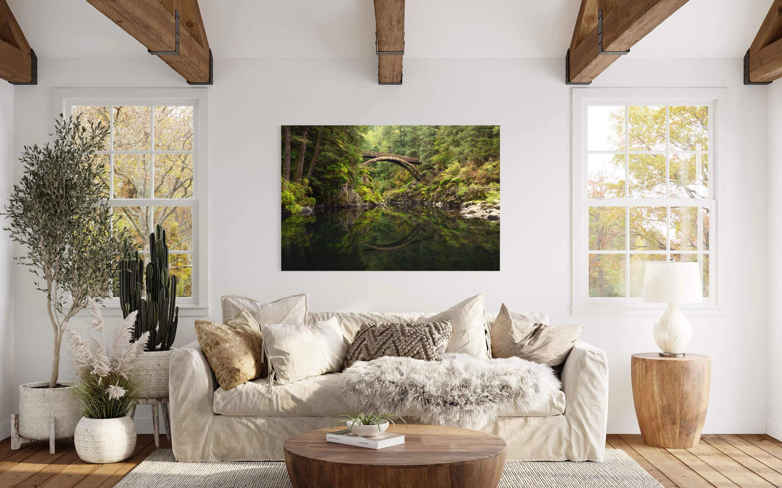 A Moulton Falls picture showing the first fall colors hangs in a living room.