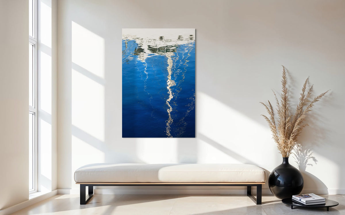 An abstract photo of a sailboat being reflected in the blue water of the San Francisco Marina hangs in an entryway. | Lars Gesing Fine Art | Nautical Wall Art