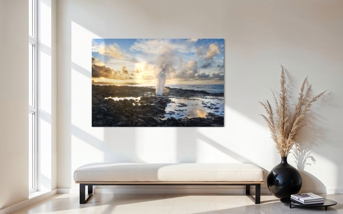 A piece of Kauai art showing a Spouting Horn photo hangs in an entryway.