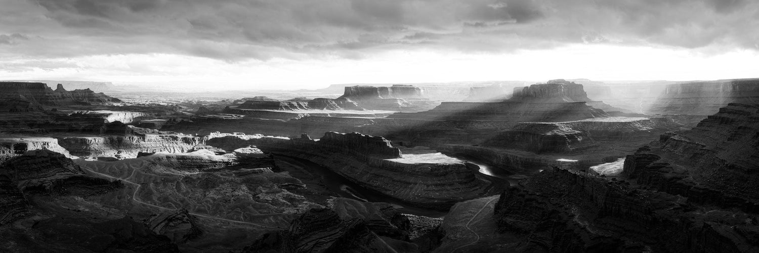 A fine art nature photograph in black and white of sunset at the canyons of Dead Horse Point State Park near Moab, Utah, very close to Canyonlands National Park.