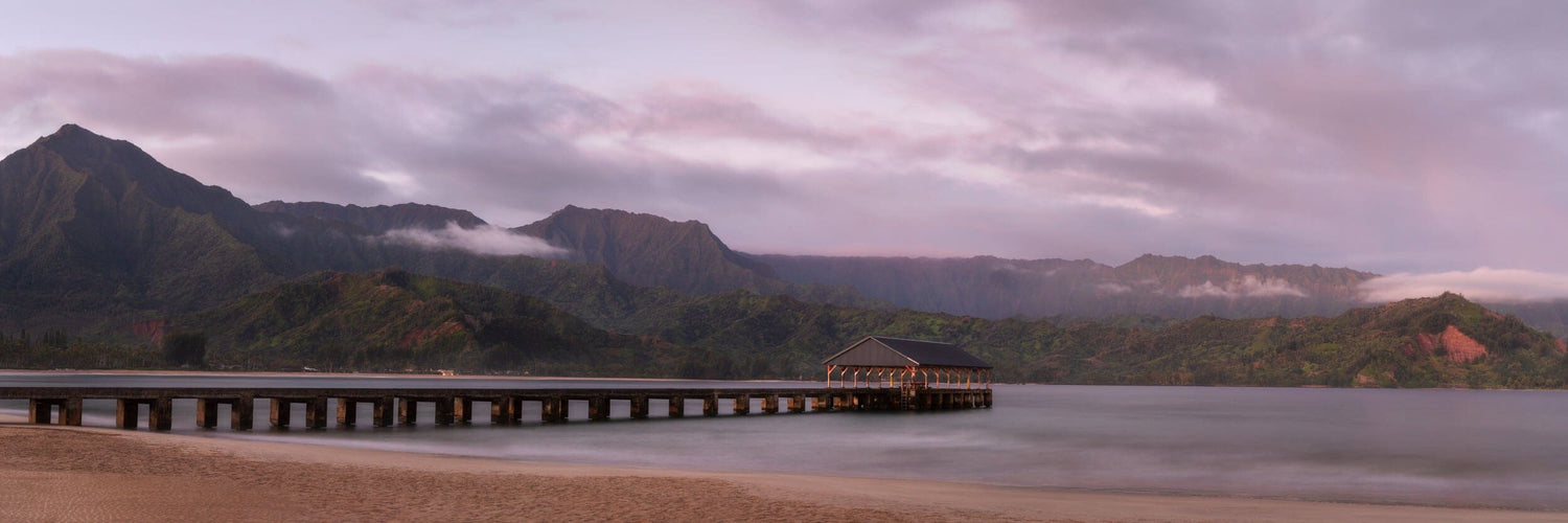 This piece of ocean landscape photography shows a picture of Hanalei Bay on Kauai at sunrise.