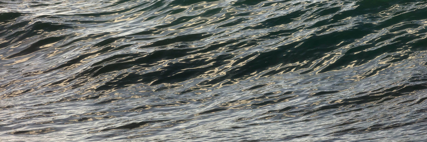 This piece of powder room wall art shows a photo of the ocean on Kauai.