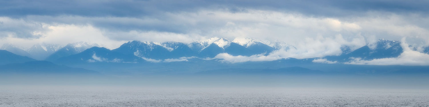 This piece of xlarge wall art shows a photo of the Olympic Mountains in Washington.