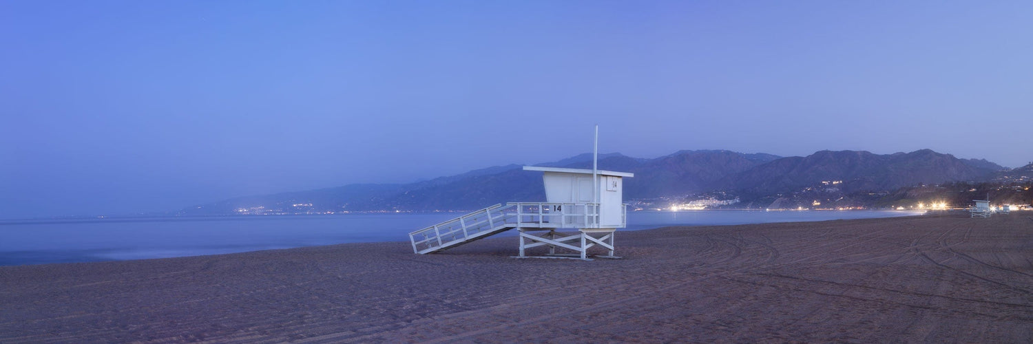 This piece of beach themed wall art shows a photo of Santa Monica Beach at sunrise.