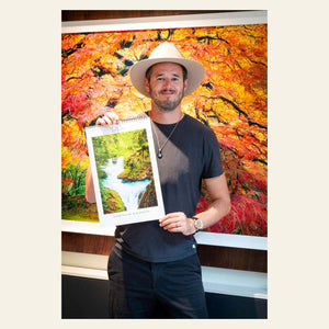 Lars Gesing holds his 2025 PNW wall art calendar.