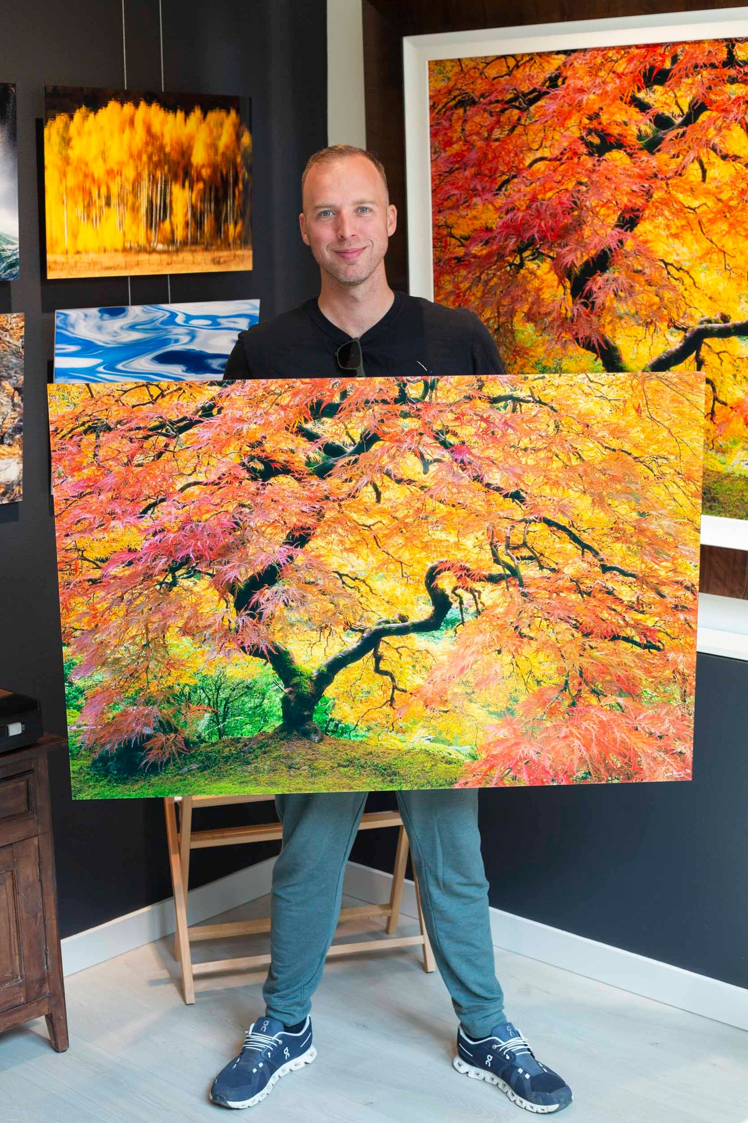 A Lars Gesing fine art nature photography art collector in the West Seattle art gallery who was happy to review the business with a fine art photograph of the famous Japanese Maple tree in the Portland Japanese Garden during peak fall colors for sale.