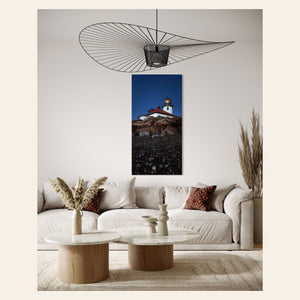 A piece of West Seattle wall art showing the Alki Lighthouse hangs in a living room.