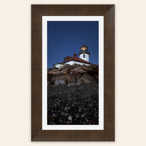 A piece of framed West Seattle wall art shows the Alki Lighthouse.