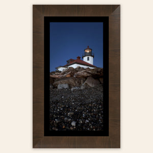 A piece of framed West Seattle wall art shows the Alki Lighthouse.