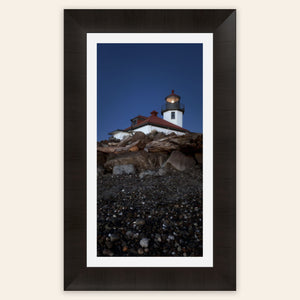 A piece of framed West Seattle wall art shows the Alki Lighthouse.