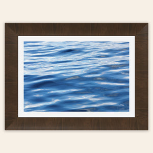 A piece of framed Anacortes art shows a photo of the water, as seen from aboard a whale watching boat tour.