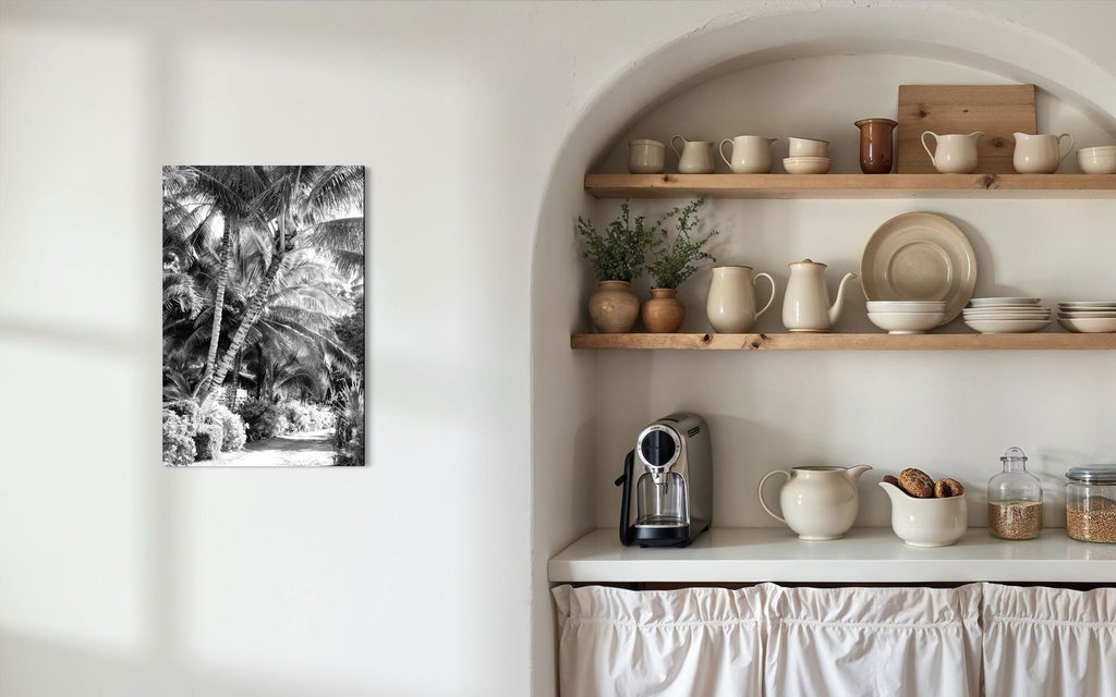 A piece of black and white Kauai art showing Anini Road hangs in a kitchen.
