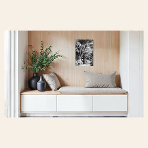 A piece of black and white Kauai art showing Anini Road hangs in an entryway.