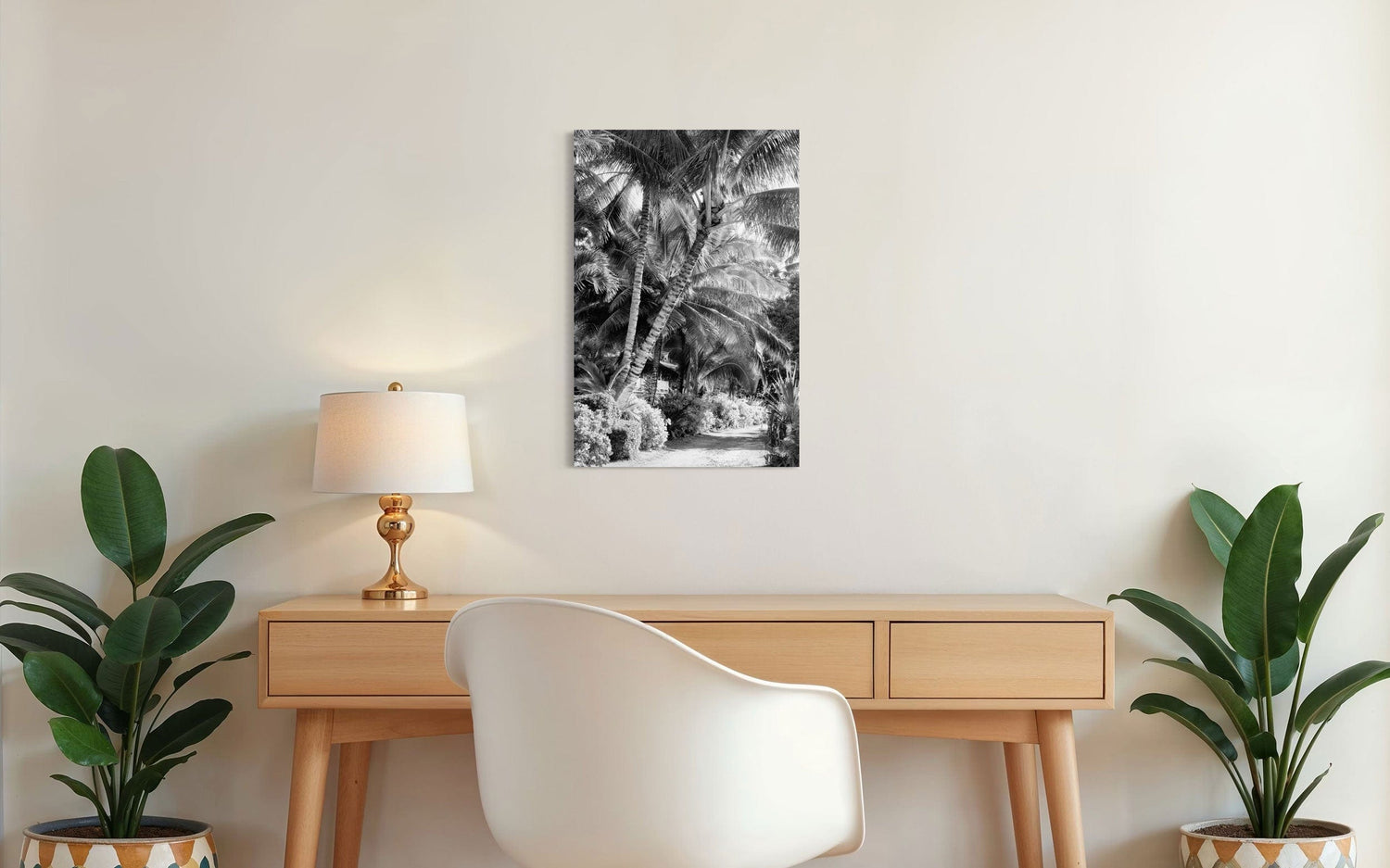 A piece of black and white Kauai art showing Anini Road hangs above a desk.