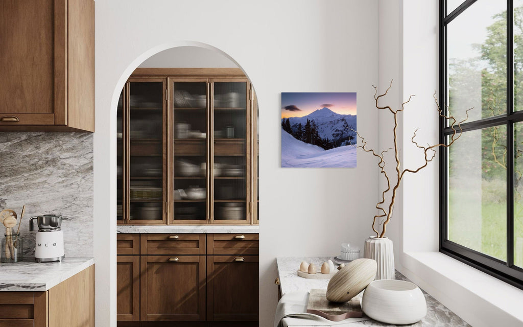 A piece of Pacific Northwest art showing a Mount Baker photo hangs in a kitchen.