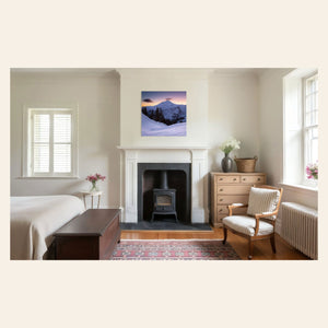 A piece of Pacific Northwest art showing a Mount Baker photo hangs in a bedroom.