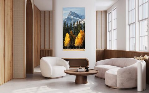 A picture of the Banff fall colors hangs in a living room.