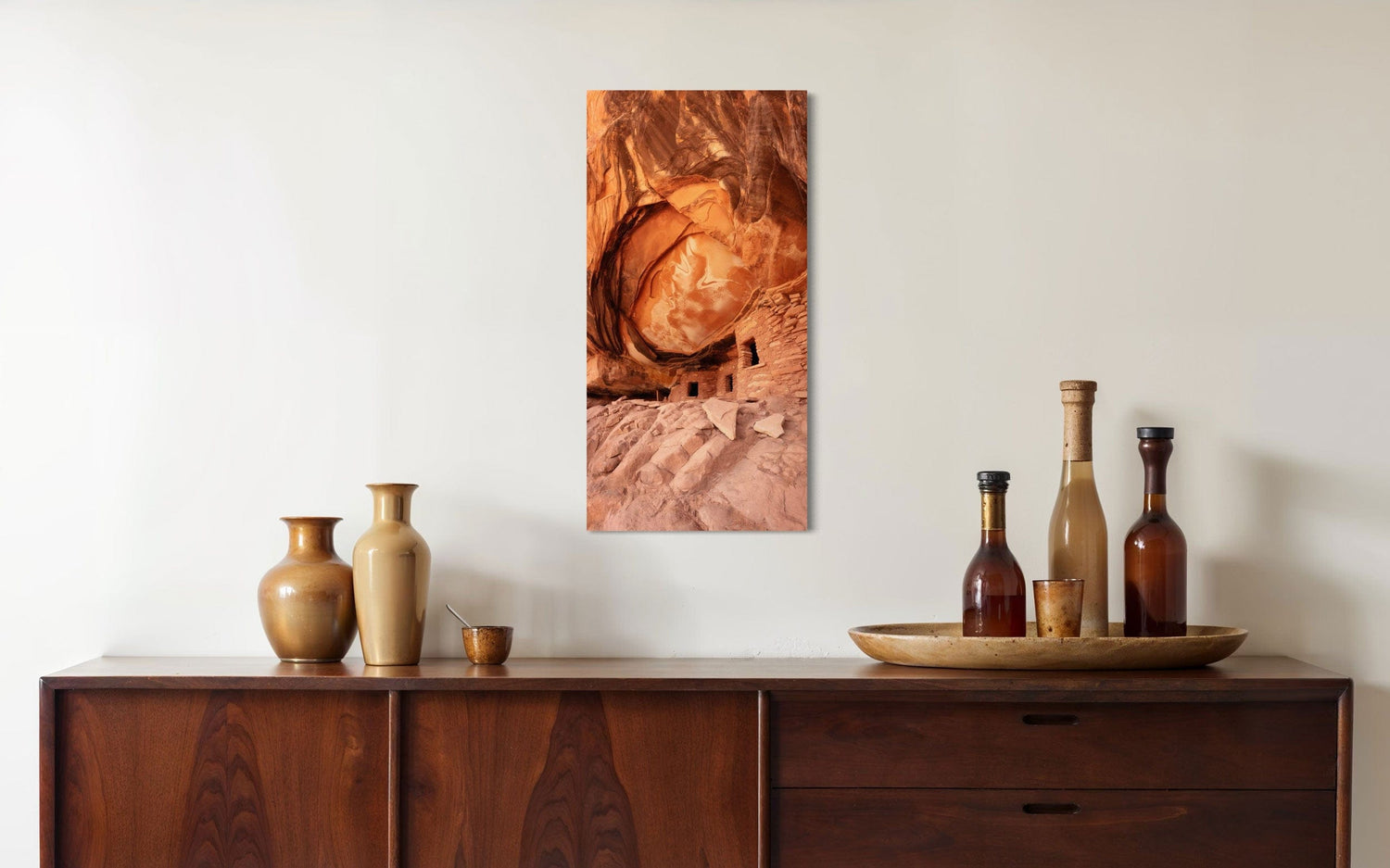 A piece of Southwest art showing a photo of an Anasazi dwelling in Bears Ears National Monument hangs above a console.