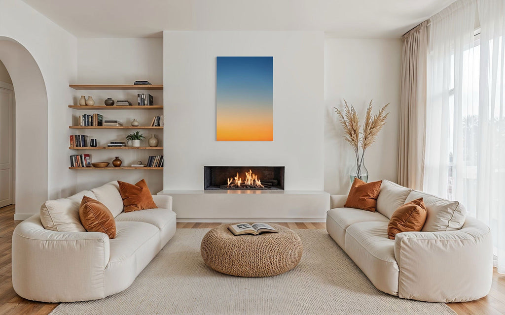 A piece of Big Sur Wall Art showing a sunset photo hangs above a fireplace.