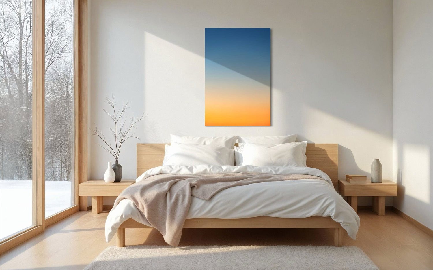 A piece of Big Sur Wall Art showing a sunset photo hangs above a bed.