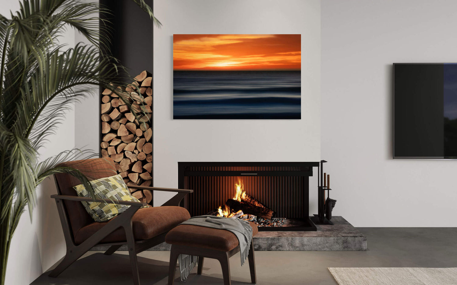A Big Sur sunset picture captured along the California coast hangs in a living room.