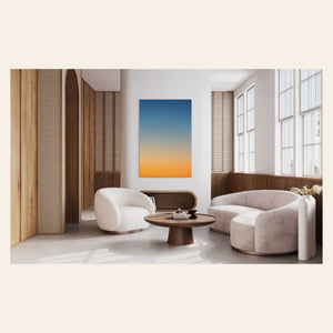 This piece of Big Sur Wall Art showcases a sunset photo hangs in a living room.