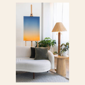 A piece of Big Sur Wall Art showing a sunset photo in a living room.