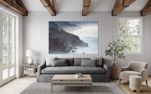 A Big Sur picture from California hangs in a living room.