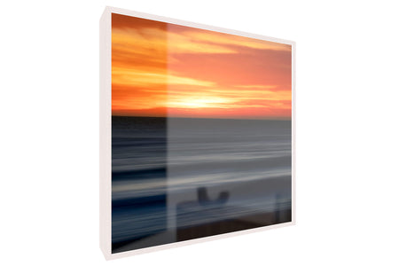 A framed Big Sur sunset picture.