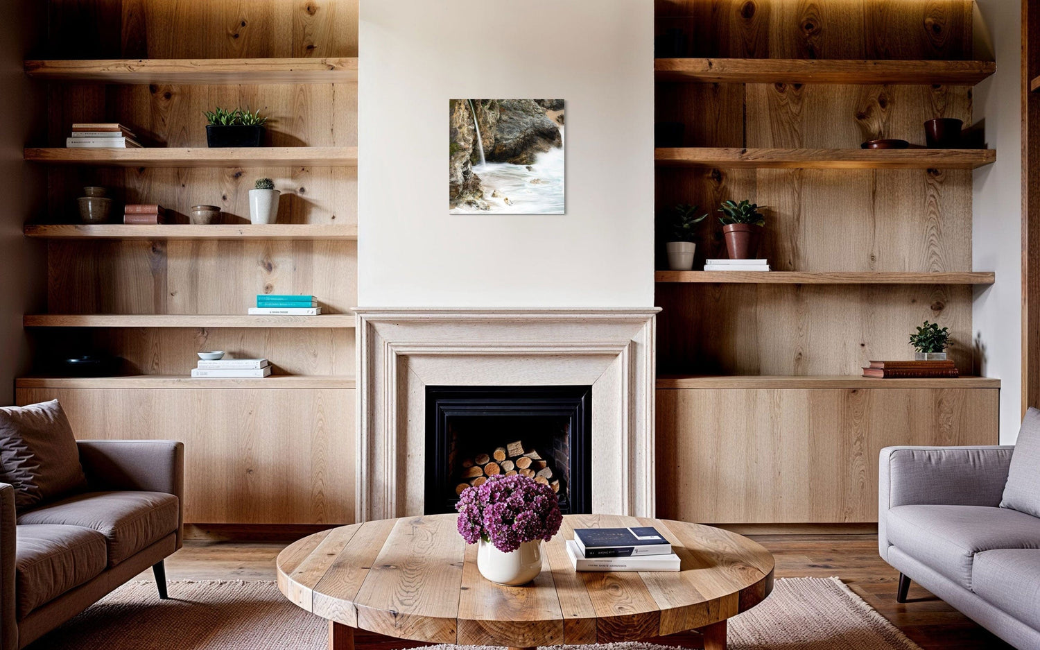 A piece of Big Sur art showing a waterfall photo hangs above a fireplace.