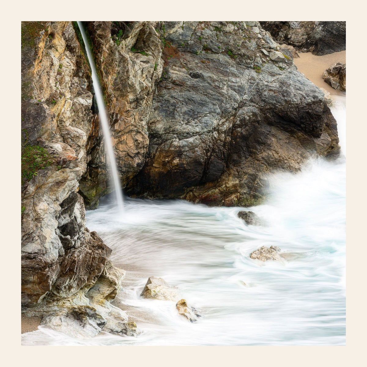 A piece of Big Sur art shows a waterfall photo.