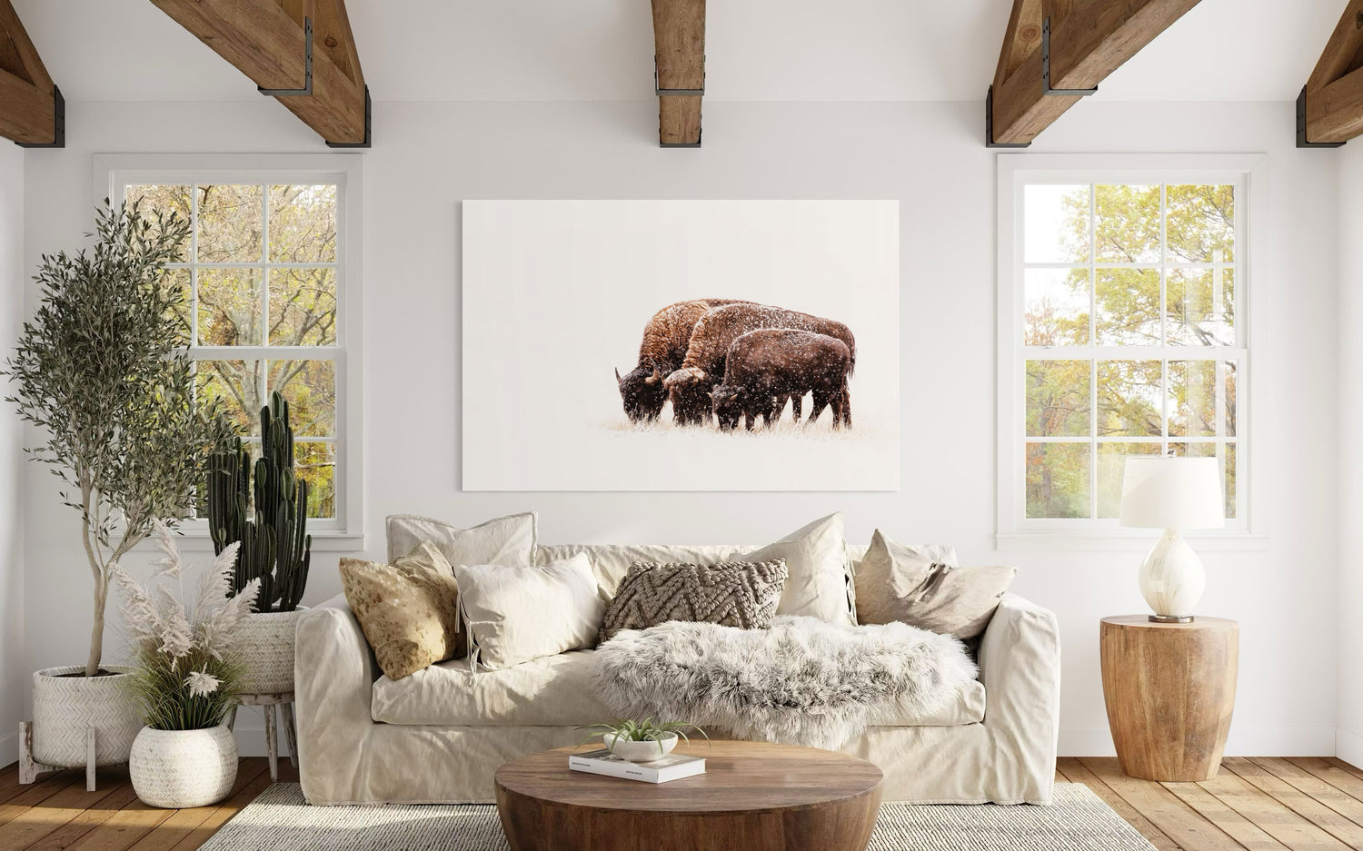 A piece of large wall art showing a bison photo hangs in a living room.