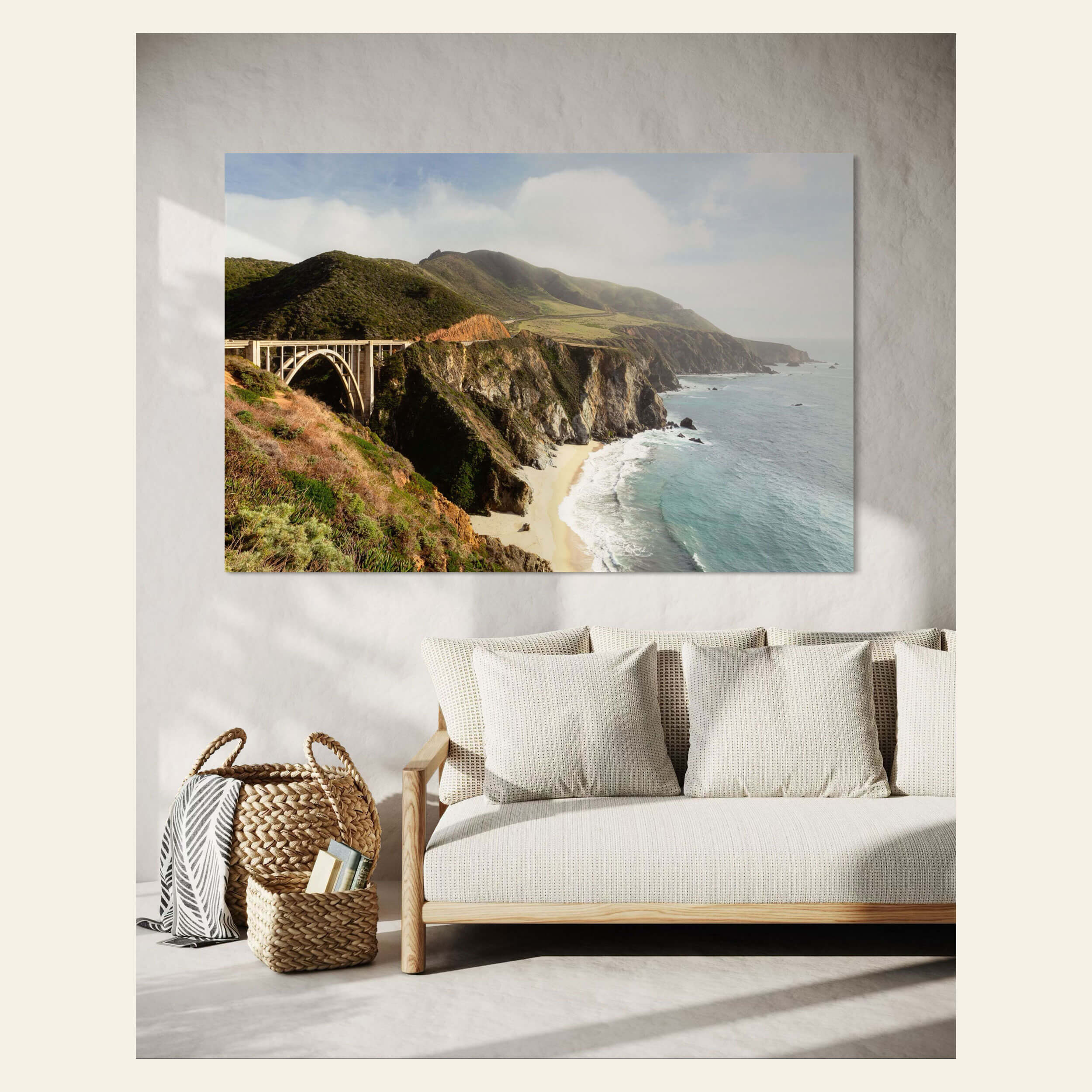 A Big Sur picture showing the Bixby Bridge hangs in a living room.