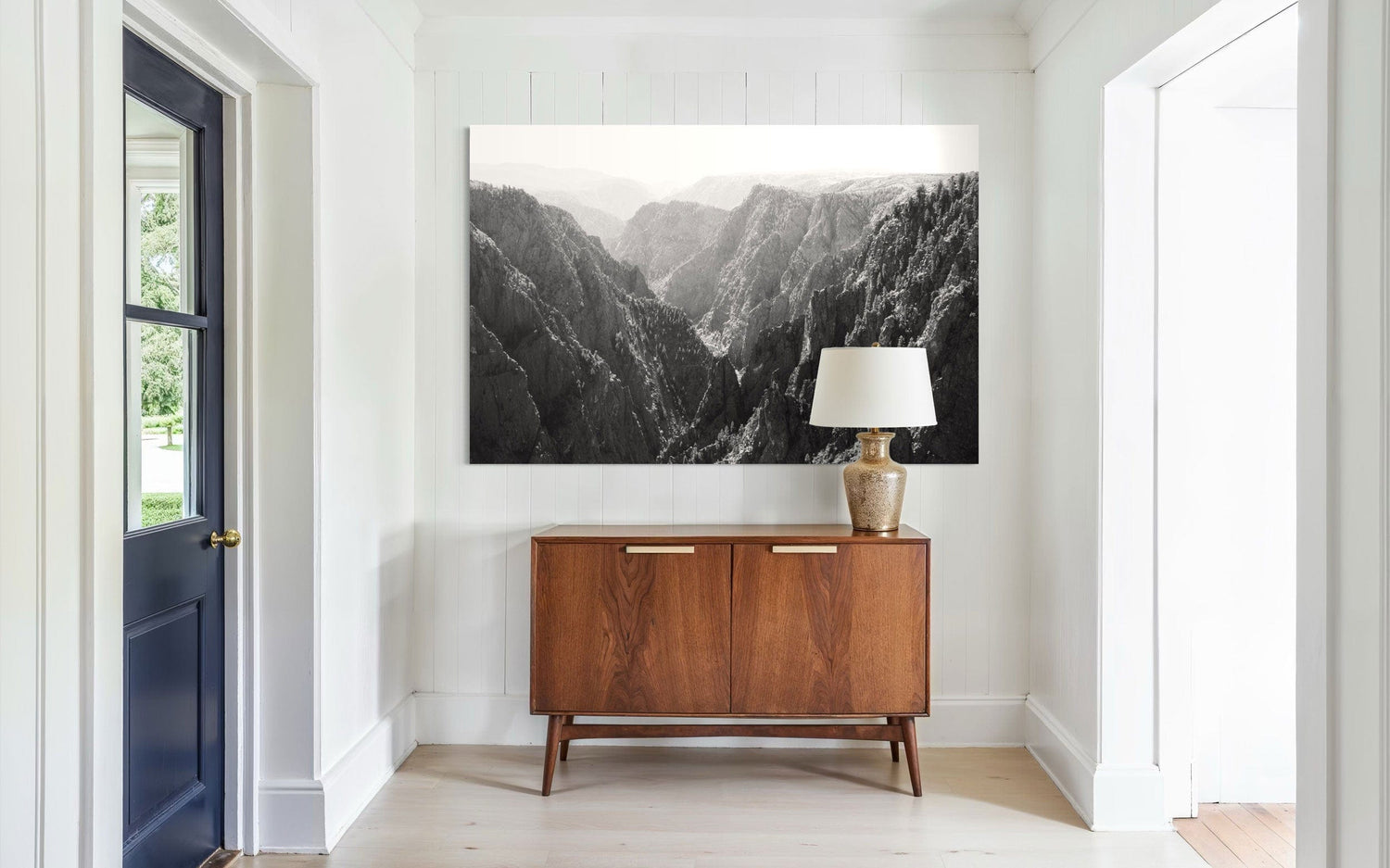 A piece of Colorado art showing a photo of the Black Canyon National Park in Gunnison hangs in an entryway.