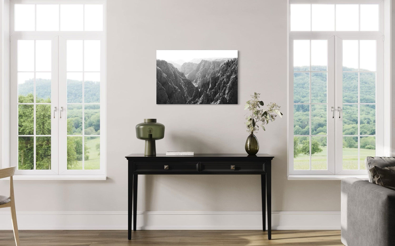A piece of Colorado art showing a photo of the Black Canyon National Park in Gunnison hangs in a dining area.