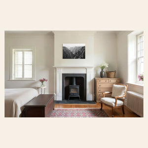 A piece of Colorado art showing a photo of the Black Canyon National Park in Gunnison hangs in a bedroom.