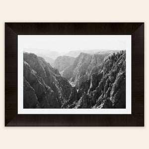 A piece of framed Colorado art shows a photo of the Black Canyon National Park in Gunnison.