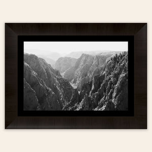 A piece of framed Colorado art shows a photo of the Black Canyon National Park in Gunnison.