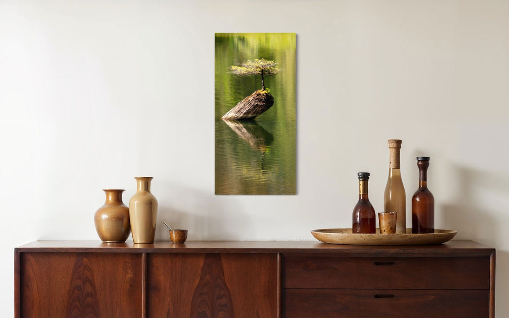 A piece of Pacific Northwest art showing a Bonsai photo from Vancouver Island hangs in a dining room.