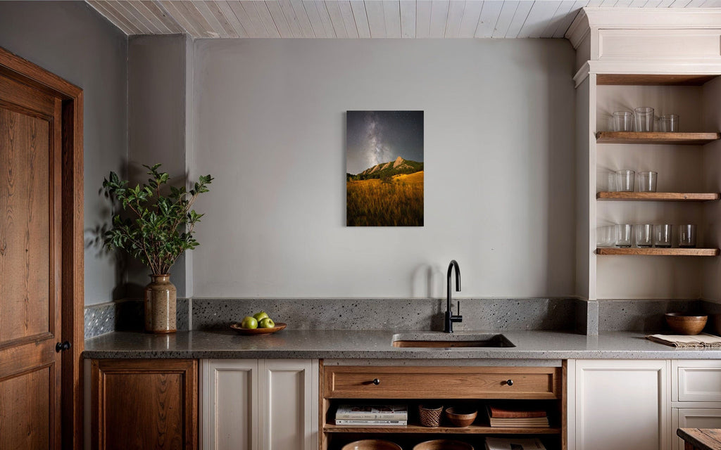 A piece of Boulder art showing the Flatirons with the Milky Way above hangs in a kitchen.