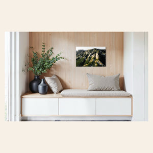 A piece of Boulder art showing an areal photo of the Flatirons along Colorado's Front Range hangs in a sitting area.