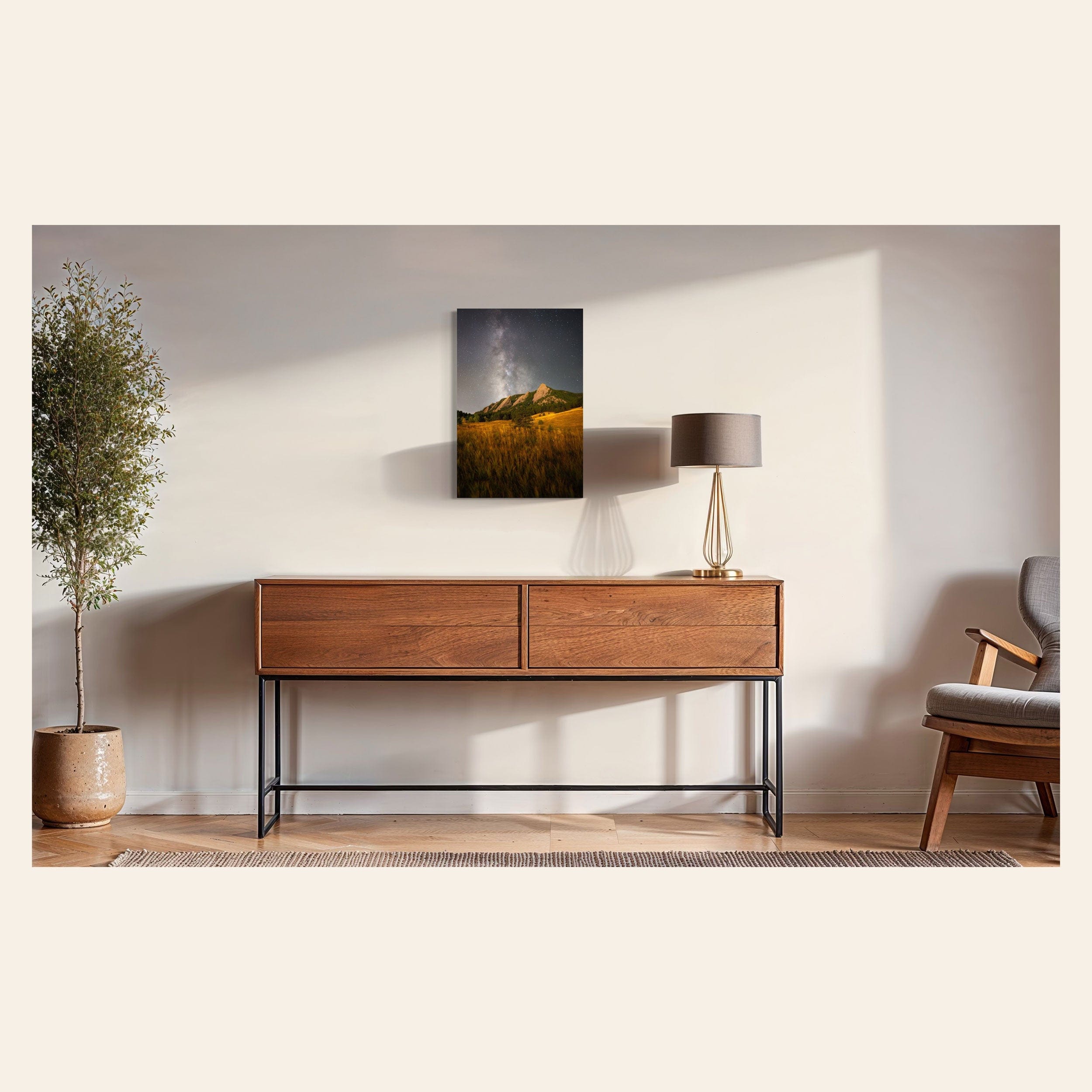 A piece of Boulder art showing the Flatirons with the Milky Way above hangs in a midcentury modern home.