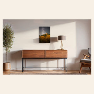 A piece of Boulder art showing the Flatirons with the Milky Way above hangs in a midcentury modern home.