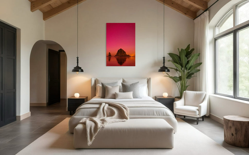 A photo of the Northern Lights in Cannon Beach hangs above a bed. | Lars Gesing Fine Art | Coastal Wall Art