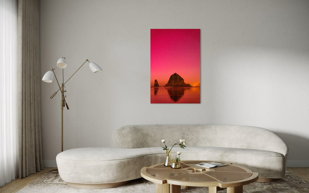A photo of the Northern Lights in Cannon Beach hangs above a couch. | Lars Gesing Fine Art | Coastal Wall Art