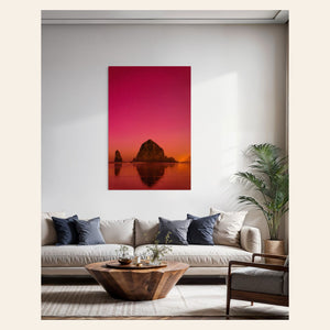 A photo of the Northern Lights in Cannon Beach hangs over a couch. | Lars Gesing Fine Art | Coastal Wall Art