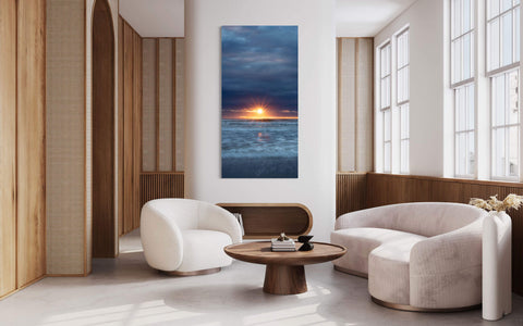 A Cannon Beach sunset picture hangs in a living room.